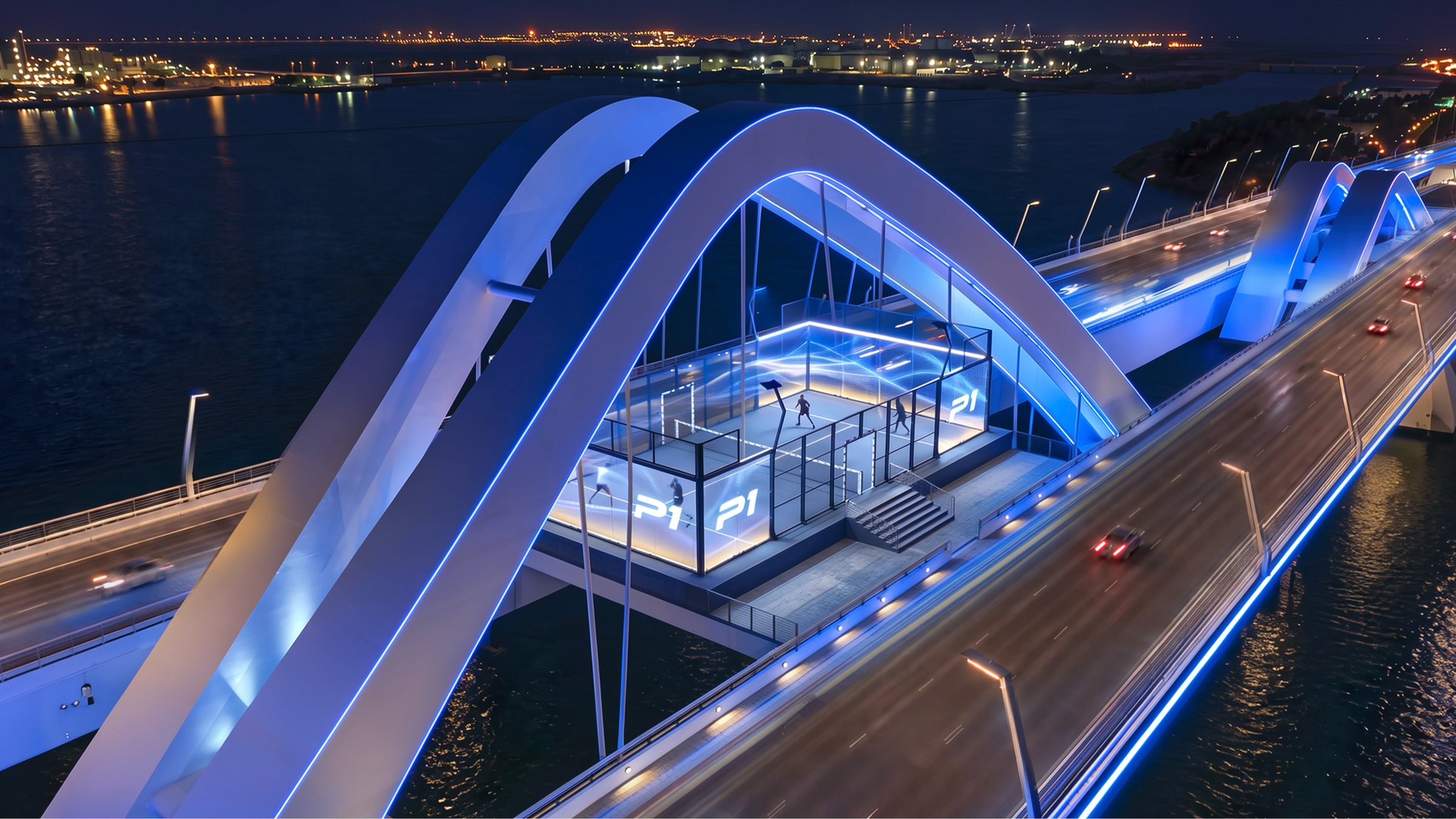 A glass padel court suspended between the blue-lit arches of a white bridge at night
