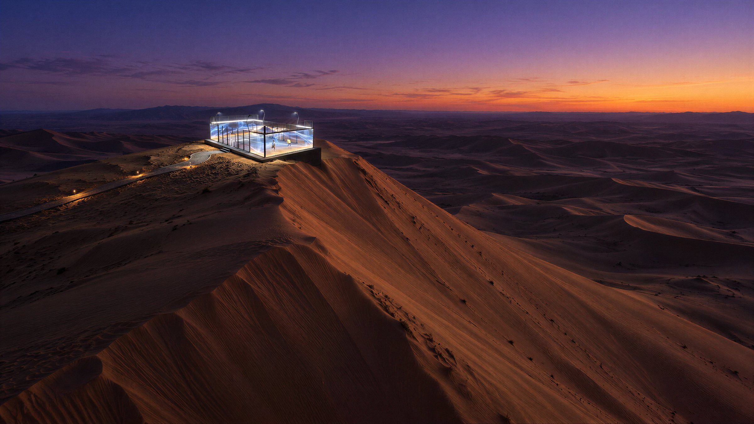 Aerial view of a glowing padel court on the crest of a high dune at dusk